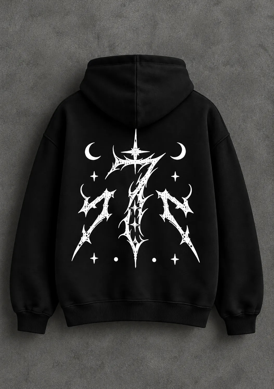 Back view of a black graphic hoodie with an intricate white celestial design and ribbed cuffs.