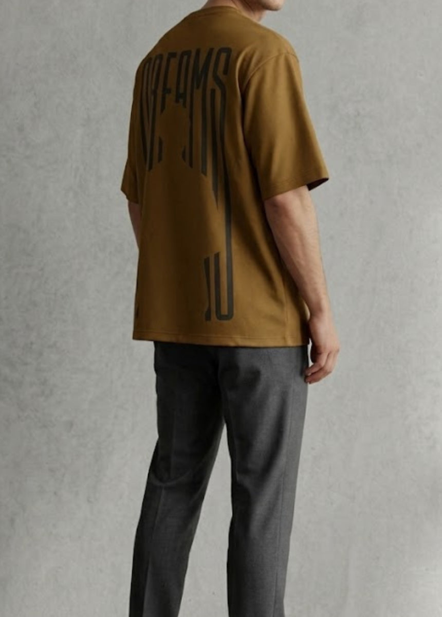Brown Dreams graphic T-shirt front view hanging on wooden hanger