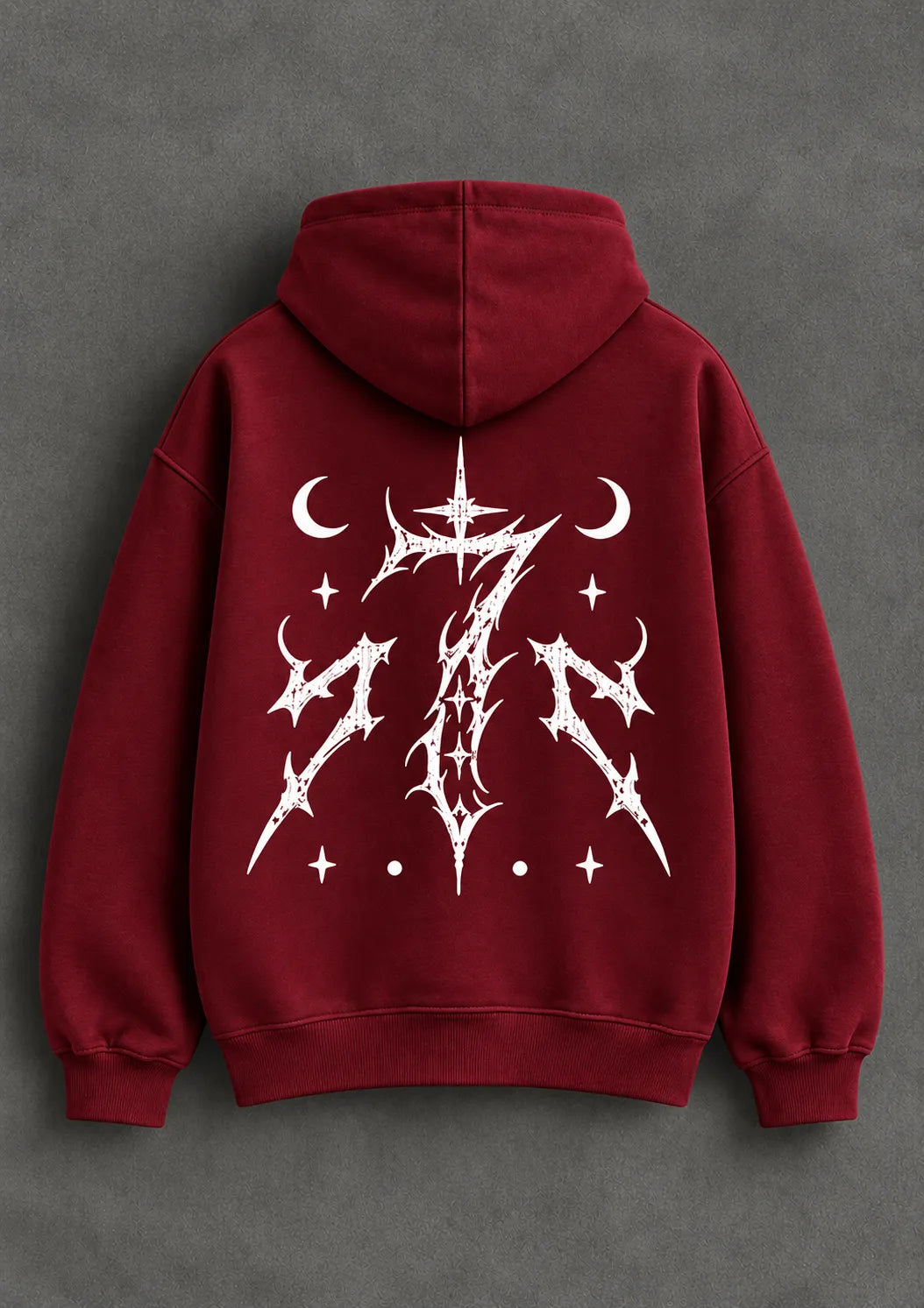 Back view of a red graphic hoodie with an intricate white celestial design and ribbed cuffs.