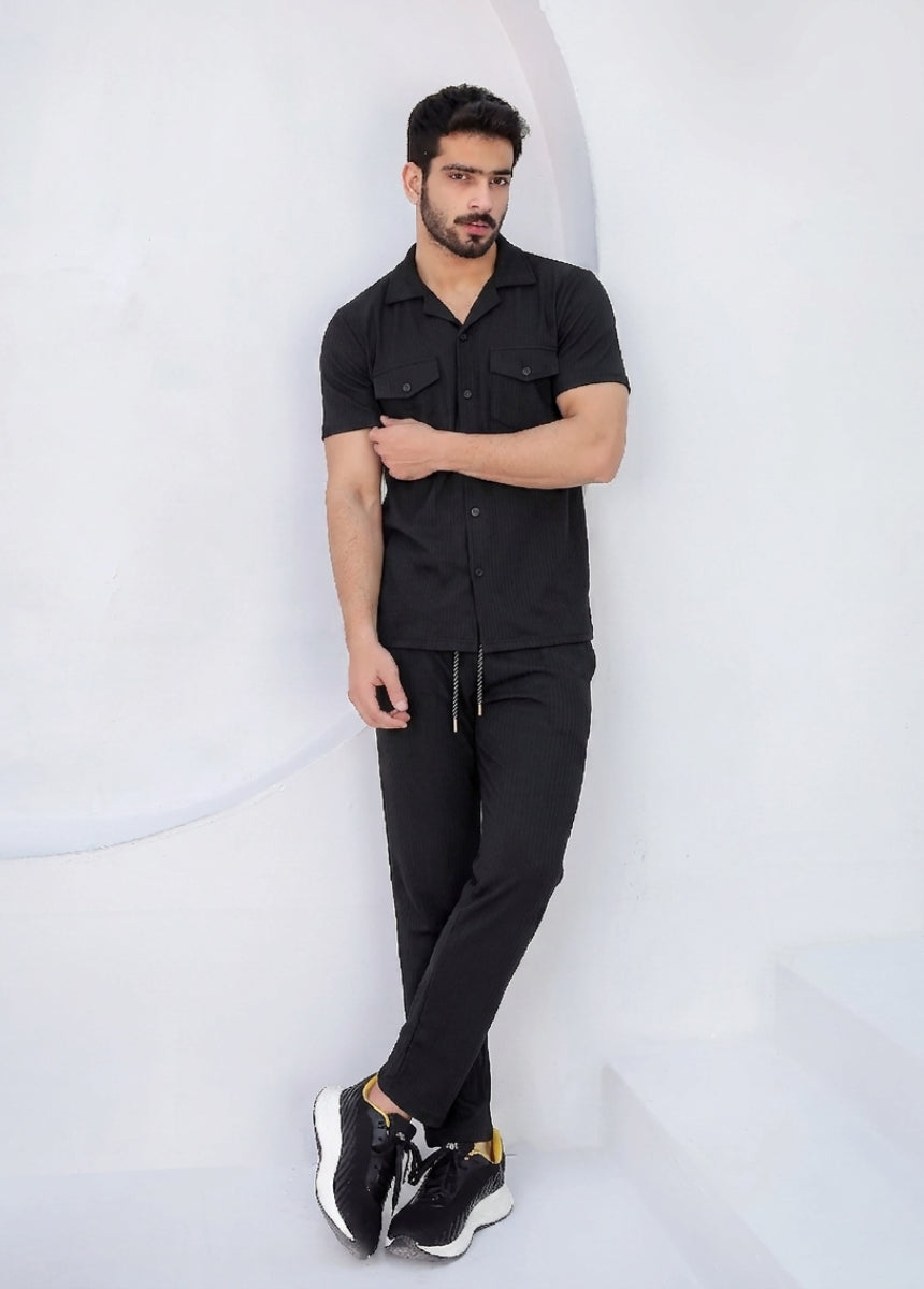 Close-up of ribbed black shirt with button pockets breathable fabric