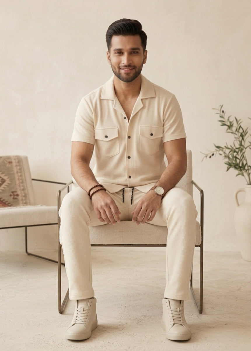 Close-up of cream textured shirt with buttons and pockets breathable fabric