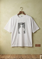 White Dreams graphic T-shirt front view hanging on wooden hanger