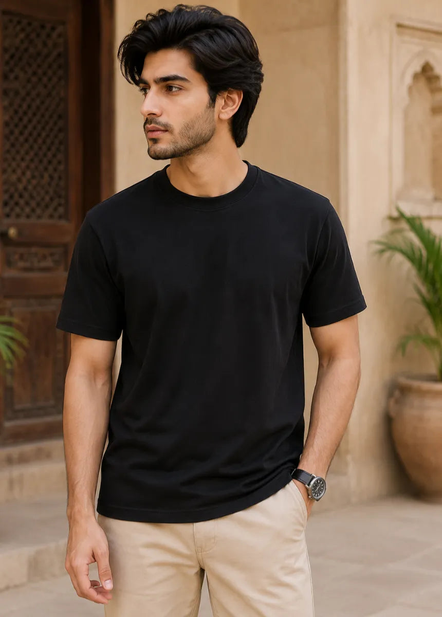 Premium black cotton t-shirt for men hanging on wooden hanger front view