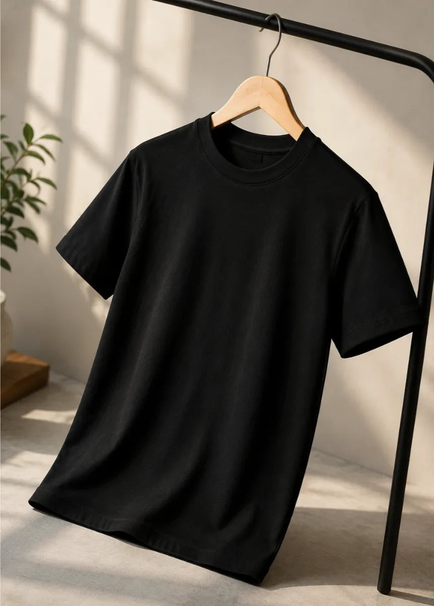 Premium black cotton t-shirt for men hanging on wooden hanger front view